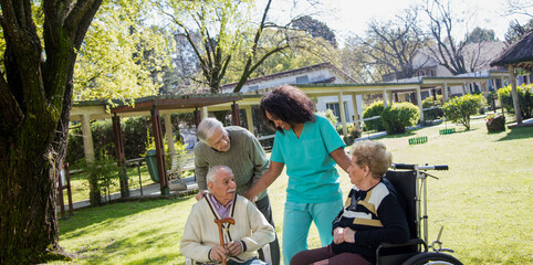 Poster - Afroamerican nurse joking with elder disabled people outdoor