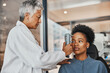 Help, eye test or black woman consulting doctor for eyesight at optometrist or ophthalmologist. African customer testing vision with senior optician helping or checking iris or retina visual health