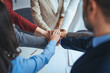 © Dragana Gordic - Close up top view of young business people putting their hands together. Stack of hands. Unity and teamwork concept. Cheerful people giving strength motivation. Co-working and teamwork concept