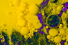 Abstract Background Of Colorful Yellow And Violet Drops