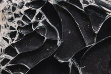 Pieces Of Broken Glass On Black Table