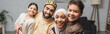 © LIGHTFIELD STUDIOS - Cheerful middle eastern parents and kids looking at camera at home, banner.