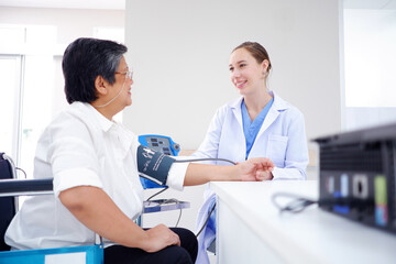 Female doctor measuring blood pressure, old woman patient, medical concept.