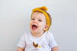 © Austockphoto - happy aussie baby girl laughing with big smile on white copy space background