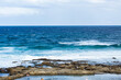 © Austockphoto - blue ocean pool rocks and sea to horizon