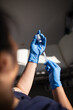 © Austockphoto - Close up shot of a syringe being inserted to a medicine glass vial by a healthcare worker