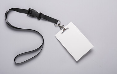 empty white id card badge mockup with black belt on gray background. staff identity name tag. space 