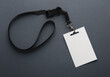 White ID card badge with black belt on black background. Mockup for design template