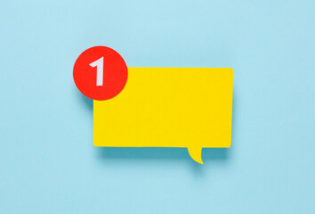 Paper cut yellow Notification speech bubble with 1 number on pink background. Social media chat, message, sms, subscribe notice alert and reminder. Top view. Creative layout