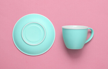 Wall Mural - Empty cup and saucer on pink background. Top view