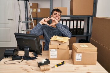 Poster - Young hispanic man working at small business ecommerce using smartphone happy face smiling with crossed arms looking at the camera. positive person.