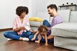 © Krakenimages.com - Couple and daughter smiling confident playing with toys sitting on the floor at home