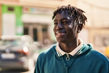 Wall Mural - African american man smiling confident looking to the side at street