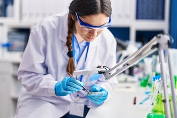 Poster - Young woman scientist working at laboratory