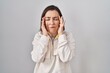 © Krakenimages.com - Middle age hispanic woman standing over isolated background with hand on head, headache because stress. suffering migraine.