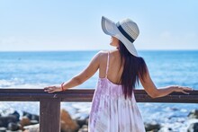Young Beautiful Hispanic Woman Tourist Leaning On Balustrade At Seaside
