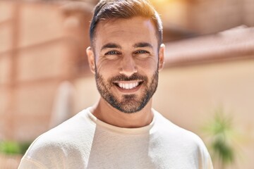 Sticker - Young hispanic man smiling confident standing at street