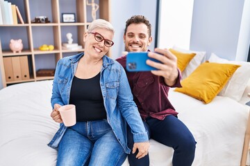 Sticker - Mother and son make selfie by the smartphone drinking coffee at bedroom