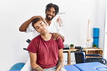 Wall Mural - Two men physiptherapist and patient having rehab session stretching neck at clinic