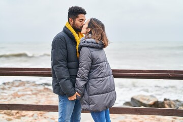 Wall Mural - Man and woman couple hugging each other and kissing at seaside