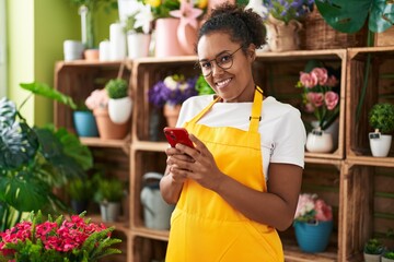 Sticker - African american woman florist smiling confident using smartphone at flower shop