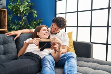 Poster - Man and woman smiling confident looking photo at home