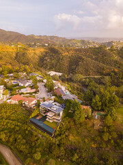 High-angle views taken from a drone of Lake Hollywood, or Hollywood Reservoir, in the Hollywood neighborhood of Los Angeles, California. Pictures taken after a large rainfall showing the lush foliage.