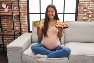 Poster - Young pregnant woman craving for food at home smiling with a happy and cool smile on face. showing teeth.