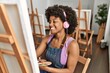 © Krakenimages.com - Young african american woman listening to music drawing at art studio