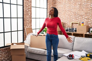 Sticker - African american woman smiling confident standing with arms open at new home