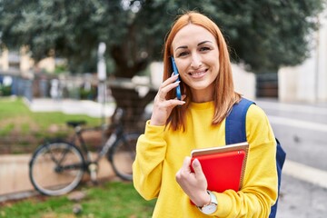 Wall Mural - Young caucasian woman student smiling confident talking on smartphone at park