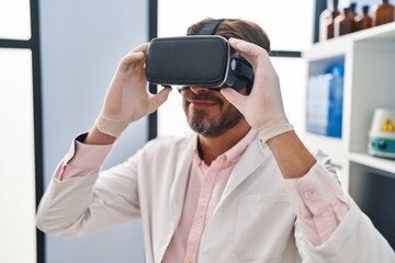 Canvas Print - Middle age man scientist using virtual reality glasses at laboratory