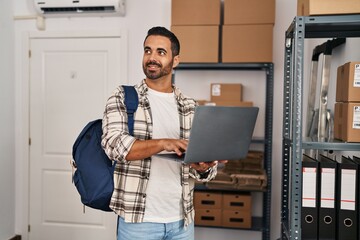 Sticker - Young hispanic man ecommerce business worker using laptop at office