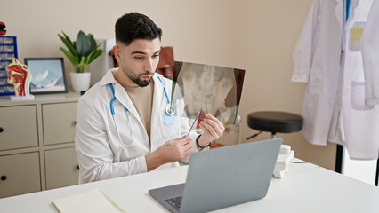 Sticker - Young arab man doctor looking xray having video call at clinic