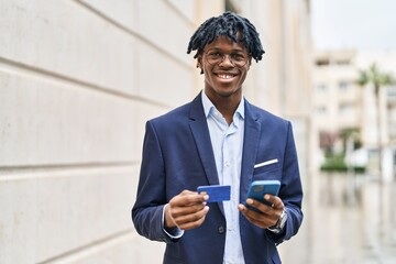 Poster - African american man executive using smartphone and credit card at street