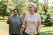 © Seventyfour - Waist up portrait of active senior woman walking with poles and smiling outdoors