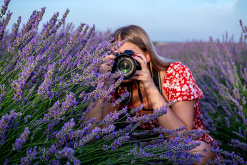 beautiful woman taking pictures outdoors with a dslr camera. female professional photographer, takin