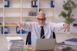 © Elnur - Old male employee working in the office