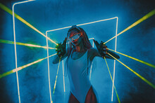 Young Woman Dancer Posing In Dark Night Club Interior With Blue Lights Green Lasers