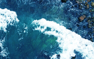 Canvas Print - Aerial view of the ocean water surface and waves. Beautiful water background texture for tourism and advertising. Tropical coast