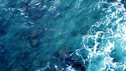 aerial view of the ocean water surface and waves. beautiful water background texture for tourism and
