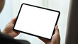 © Prathankarnpap - Close up view of man hands holding mock up digital tablet. White empty screen for text information or content