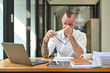 © Prathankarnpap - Tired caucasian man office worker holding glasses and rubbing nose suffering from chronic dry eye syndrome bridge