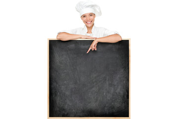 Chef showing menu sign blackboard happy. Empty menu chalkboard with copy space for text. Chef, baker or cook isolated cutout PNG on transparent background. Mixed race Asian Caucasian female model.