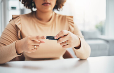 Diabetes, finger of black woman and blood test in hands, healthcare and medicine in home. Health, innovation and technology, diabetic person with digital glucometer checking glucose or sugar level.