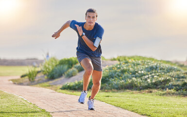 Canvas Print - Fitness, runner in park and man running for cardio, action and energy outdoor, health and wellness in active lifestyle. Exercise, training for race or marathon, healthy and freedom with run in nature