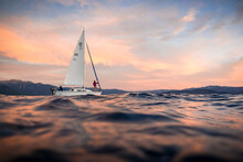 A Sailboat On Lake Tahoe At Sunset.