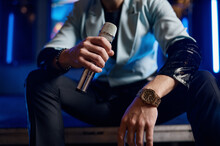 Cropped Shot Of Male Pop Singer Hand Holding Microphone
