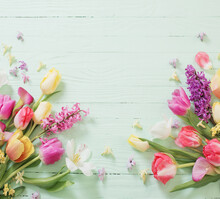 Spring Flowers On Green Wooden Background
