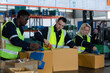 © Wosunan - Group of worker in auto parts warehouse Packing small parts in boxes after inspecting the car parts that are ready to be sent to the car assembly plant.